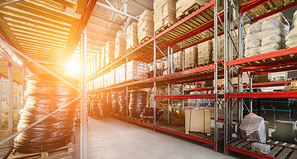 Industrial stock image of warehouse with storage and sunlight shining through 