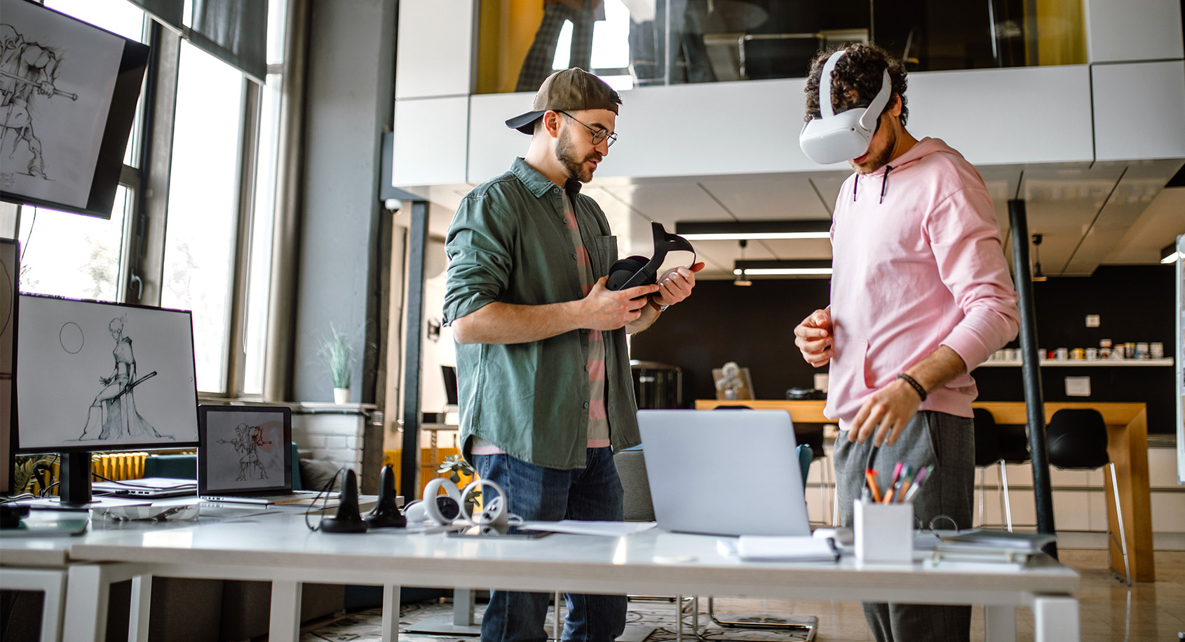 Two people using a VR headset designing video games